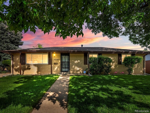 3018 S Depew St, Denver, CO 80227 - ranch-style home with a front yard and brick siding