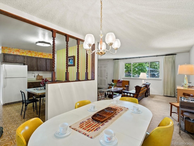 3018 S Depew St, Denver, CO 80227 - dining room featuring a textured ceiling and a chandelier