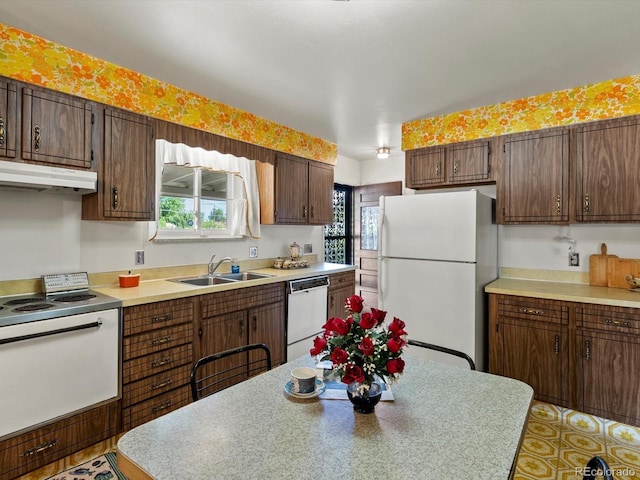 3018 S Depew St, Denver, CO 80227 - kitchen featuring white appliances, a sink, under cabinet range hood, and healthy amount of natural light