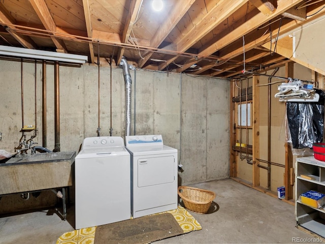 3018 S Depew St, Denver, CO 80227 - unfinished below grade area featuring washer and clothes dryer and a sink