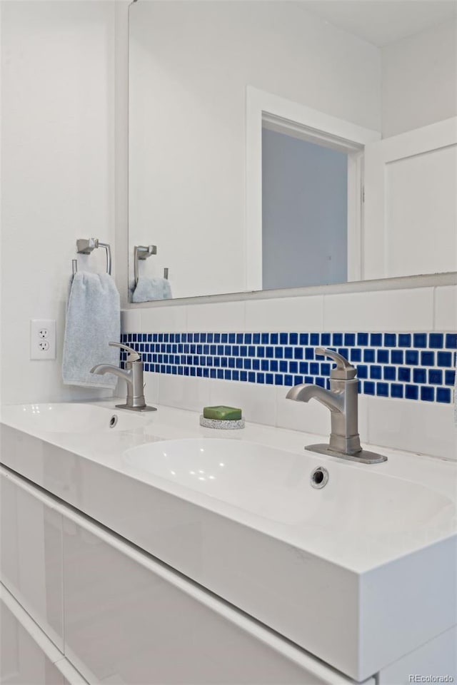 bathroom featuring vanity and decorative backsplash