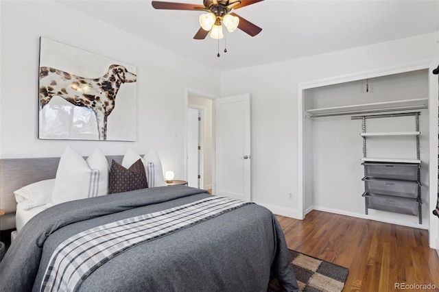 bedroom with ceiling fan, a closet, wood finished floors, and baseboards