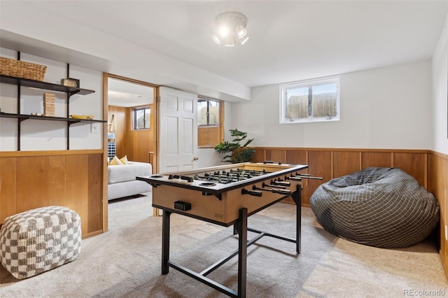 game room with carpet floors, wood walls, and wainscoting