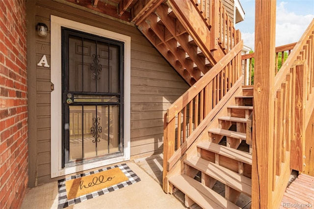 doorway to property featuring brick siding