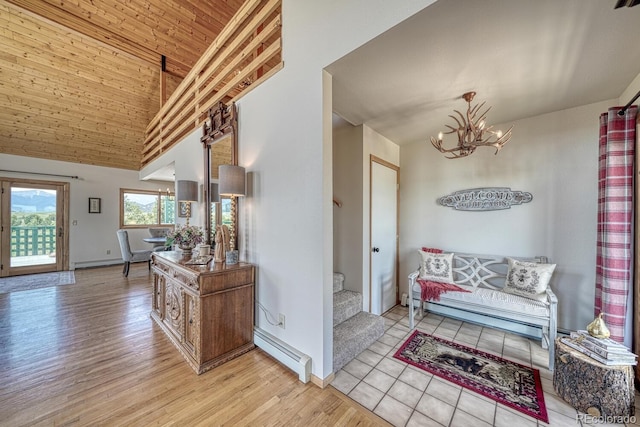895 Acorn Rd, Cotopaxi, CO 81223 - foyer entrance featuring a baseboard heating unit, a chandelier, high vaulted ceiling, and light wood-style flooring