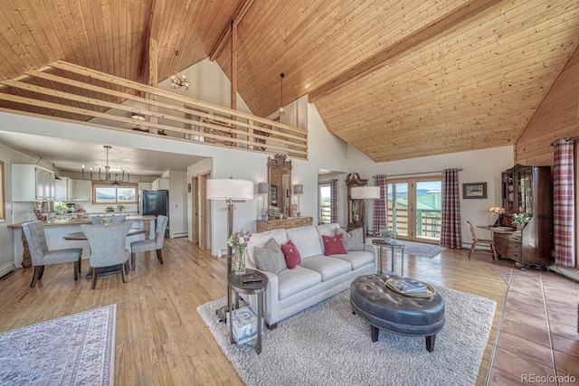 895 Acorn Rd, Cotopaxi, CO 81223 - living area with high vaulted ceiling, a chandelier, plenty of natural light, light wood finished floors, and a wooden ceiling with exposed beams