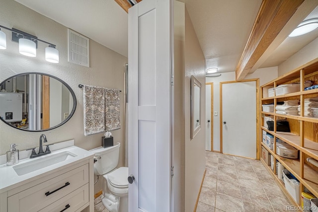 895 Acorn Rd, Cotopaxi, CO 81223 - full bathroom featuring vanity, stone finish flooring, a textured wall, and water heater