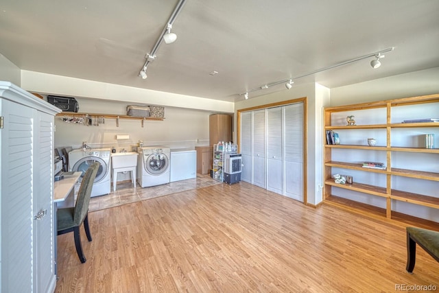 895 Acorn Rd, Cotopaxi, CO 81223 - washroom with rail lighting, washing machine and dryer, and wood finished floors