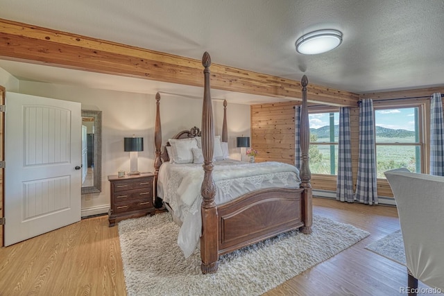 895 Acorn Rd, Cotopaxi, CO 81223 - bedroom featuring wood finished floors, a textured ceiling, baseboard heating, and a baseboard heating unit