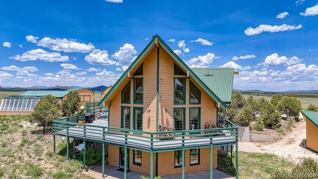 895 Acorn Rd, Cotopaxi, CO 81223 - back of property with a metal roof, a deck with mountain view, and a patio area