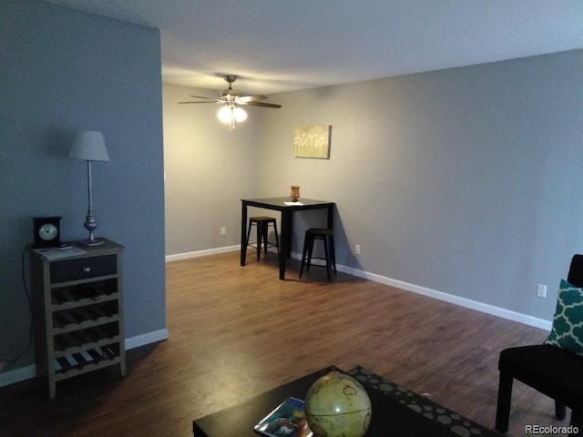 sitting room featuring ceiling fan, wood finished floors, and baseboards