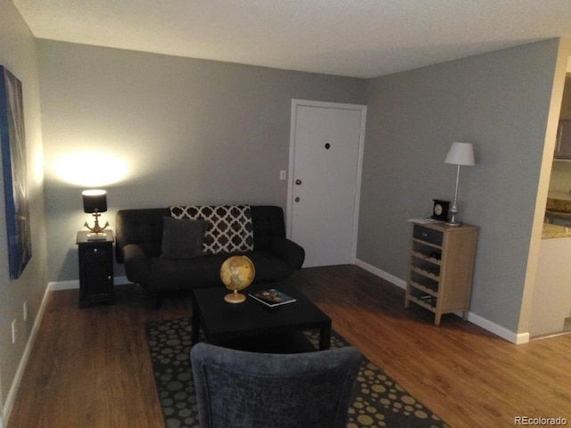 living room featuring wood finished floors and baseboards
