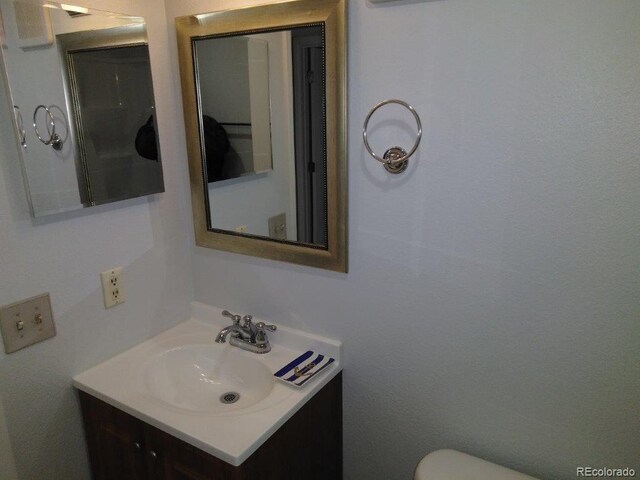 bathroom featuring vanity and toilet