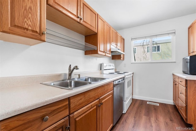 kitchen featuring white electric range oven, black microwave, light countertops, and a sink