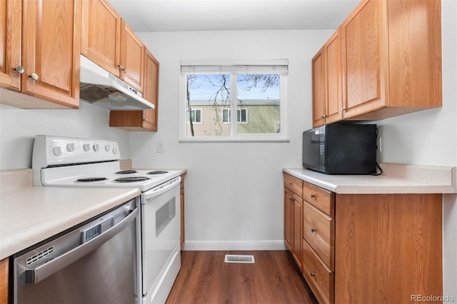 kitchen featuring white electric range oven, light countertops, stainless steel dishwasher, black microwave, and under cabinet range hood