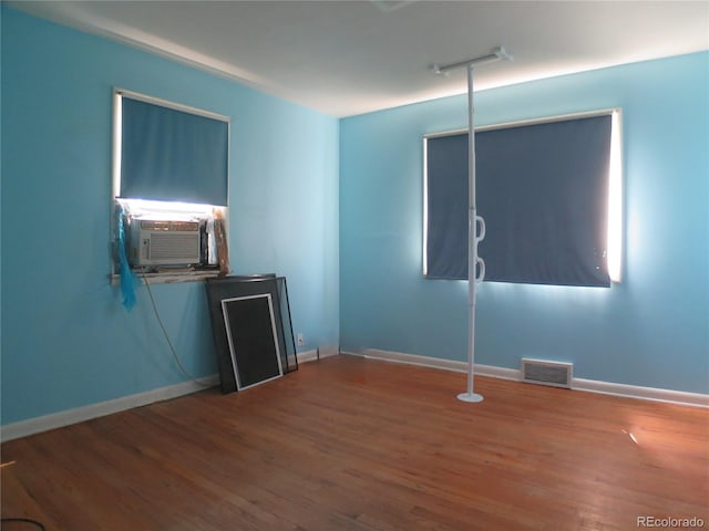 875 Kenton St, Aurora, CO 80010 - empty room with cooling unit and wood finished floors