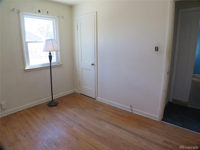 875 Kenton St, Aurora, CO 80010 - unfurnished bedroom with light wood-style flooring and baseboards