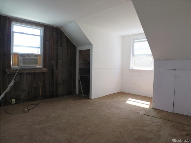 875 Kenton St, Aurora, CO 80010 - additional living space with carpet floors, lofted ceiling, cooling unit, and wooden walls
