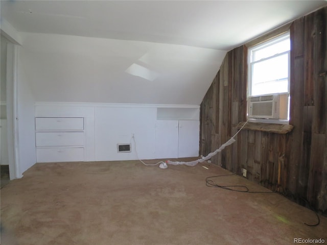 875 Kenton St, Aurora, CO 80010 - additional living space featuring vaulted ceiling, carpet, wood walls, and cooling unit