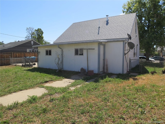 875 Kenton St, Aurora, CO 80010 - rear view of house with a shingled roof