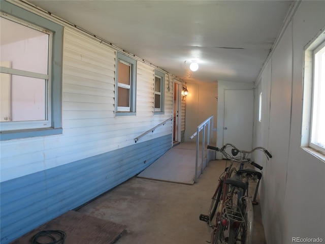 875 Kenton St, Aurora, CO 80010 - hall featuring concrete flooring and wooden walls