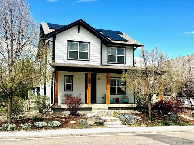 2831 Shadow Lake Rd, Lafayette, CO 80026 - view of front of property featuring covered porch, solar panels, and roof with shingles