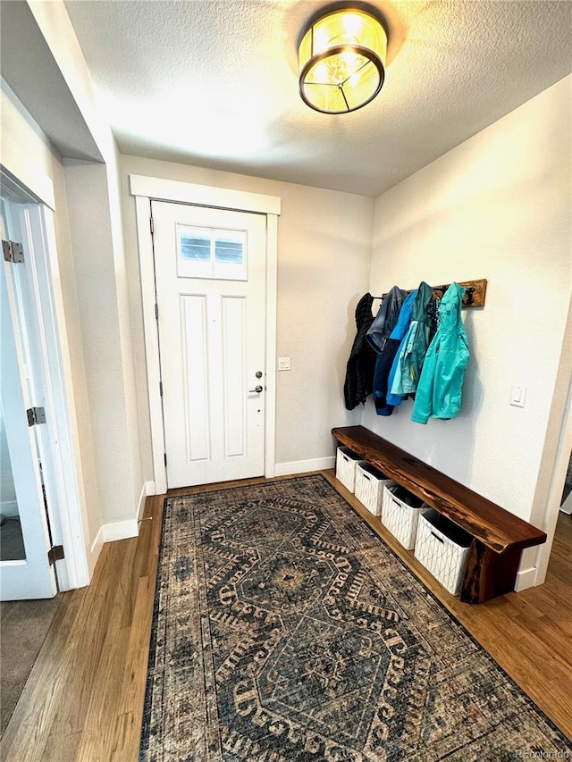 2831 Shadow Lake Rd, Lafayette, CO 80026 - mudroom featuring wood finished floors, baseboards, and a textured ceiling