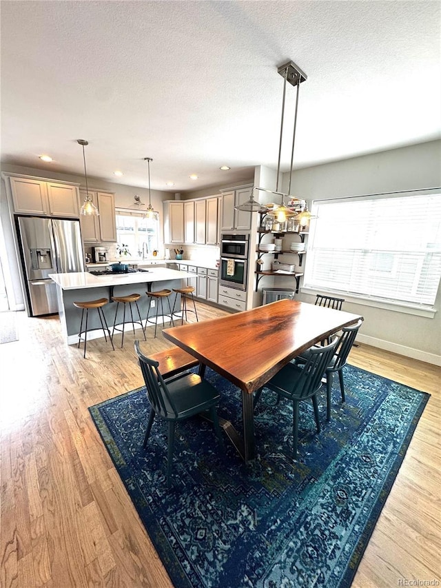 2831 Shadow Lake Rd, Lafayette, CO 80026 - dining area with recessed lighting, light wood finished floors, a textured ceiling, and baseboards