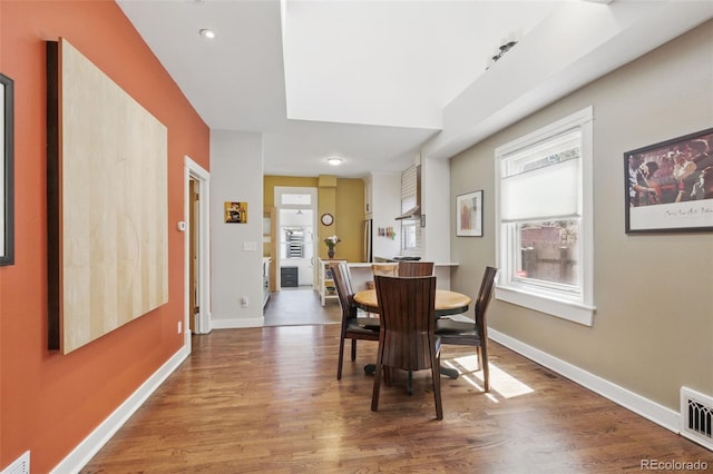 dining area with wood finished floors, baseboards, visible vents, and recessed lighting
