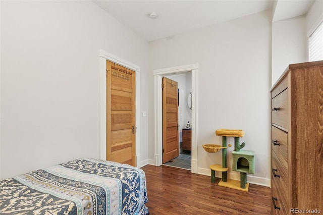 bedroom featuring wood finished floors and baseboards