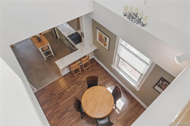 living area featuring baseboards and wood finished floors
