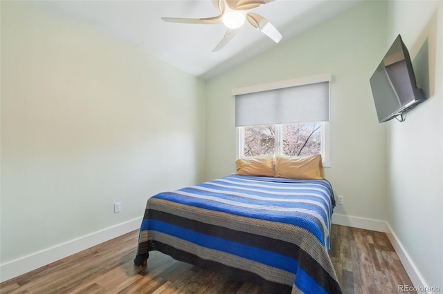 bedroom featuring wood finished floors, ceiling fan, baseboards, and lofted ceiling