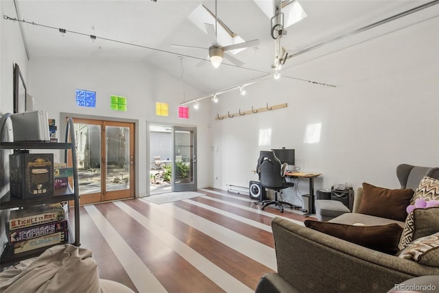 interior space with high vaulted ceiling, french doors, a ceiling fan, and wood finished floors