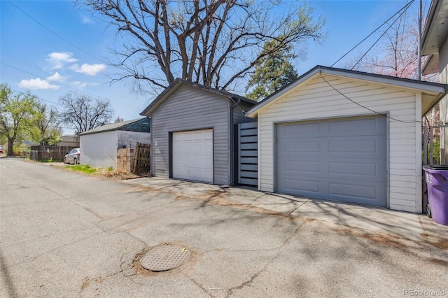 detached garage featuring fence