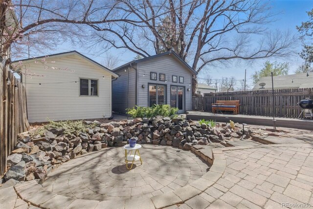 view of patio / terrace with fence and an outdoor structure