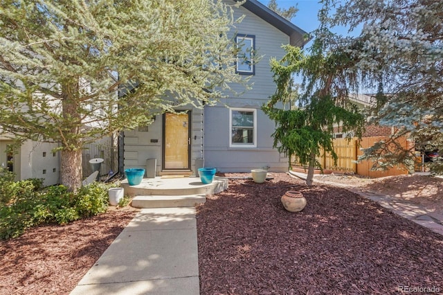 view of front of property featuring fence