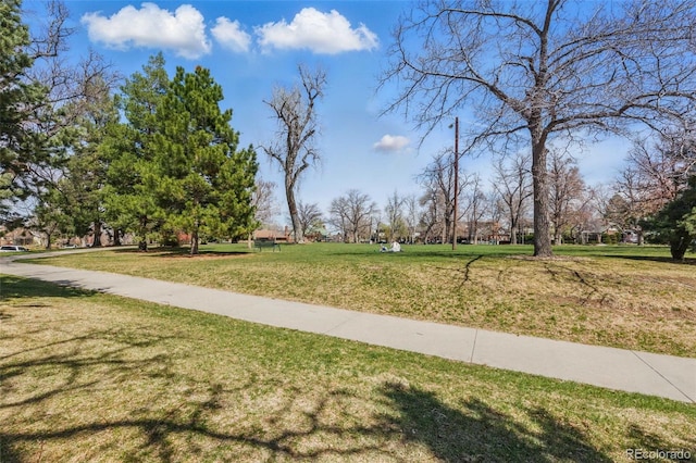 view of home's community with a yard