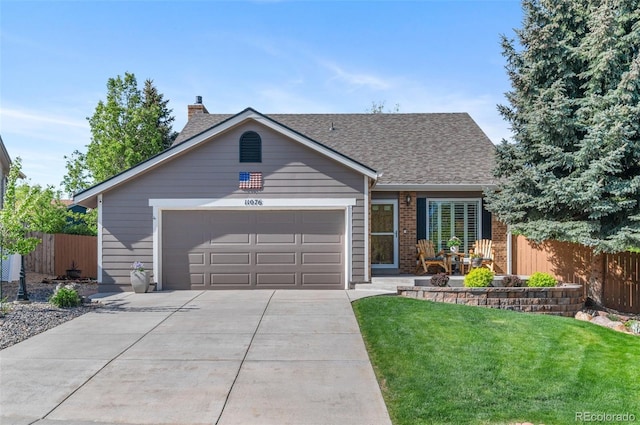 view of front of property with driveway, an attached garage, brick siding, a chimney, and a shingled roof