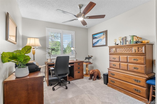 office with light carpet, a ceiling fan, and a textured ceiling