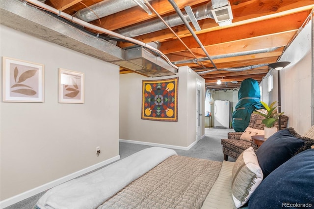 bedroom with freestanding refrigerator, baseboards, and carpet flooring