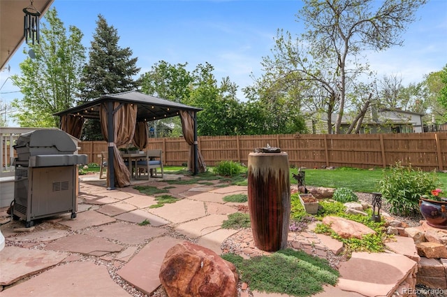 view of patio / terrace with a gazebo, a grill, and outdoor dining area