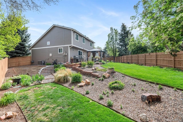 back of property featuring a gazebo, central AC unit, and a patio