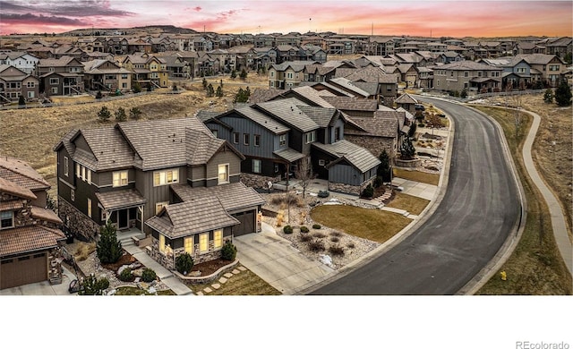 aerial view at dusk featuring a residential view