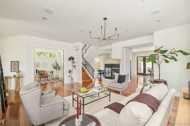 2990 Osceola St, Denver, CO 80212 - living room featuring a chandelier, light wood-style floors, a multi sided fireplace, stairs, and recessed lighting