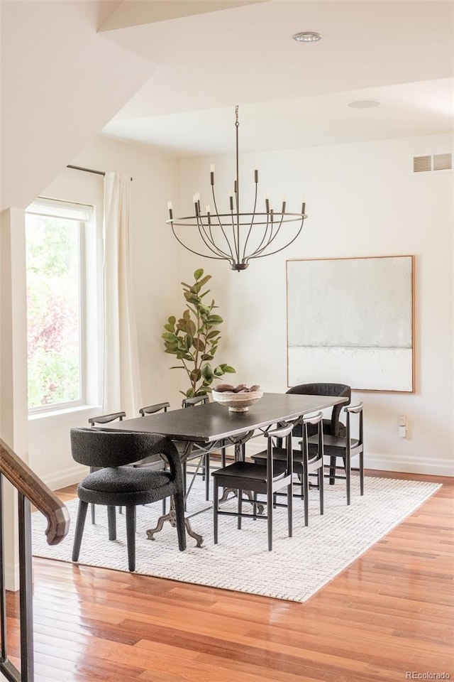 2990 Osceola St, Denver, CO 80212 - dining space featuring light wood finished floors, a chandelier, and baseboards
