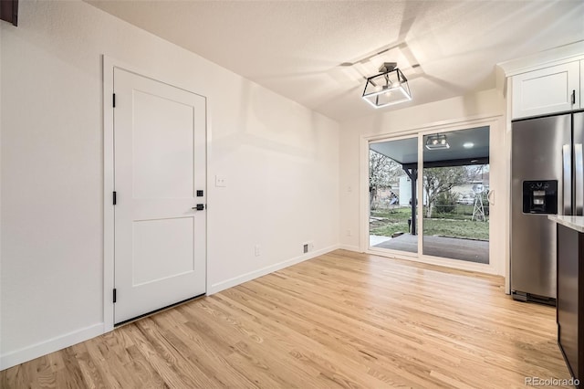 10751 W 66th Ave, Arvada, CO 80004 - unfurnished dining area with baseboards and light wood-style flooring