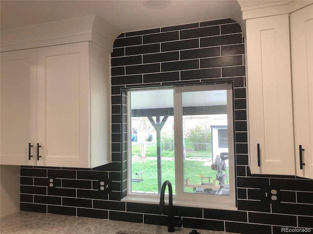 10751 W 66th Ave, Arvada, CO 80004 - interior details featuring a sink, white cabinets, and tasteful backsplash