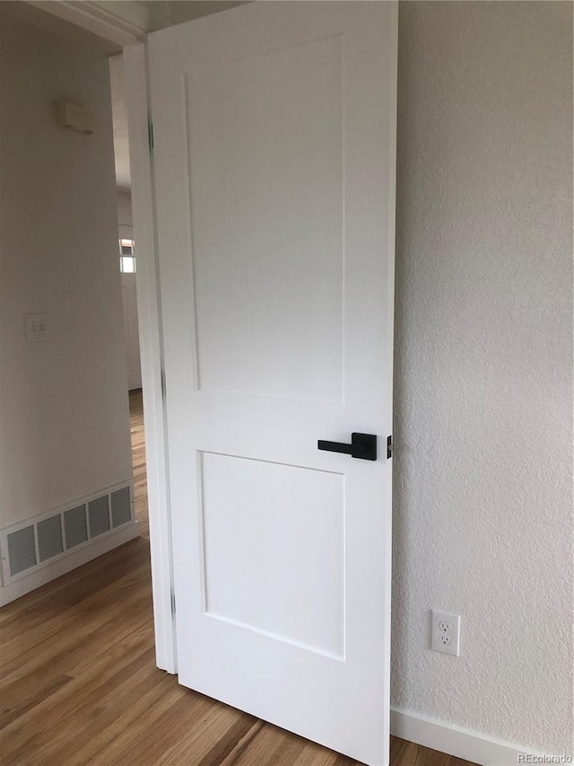10751 W 66th Ave, Arvada, CO 80004 - details featuring baseboards, a textured wall, wood finished floors, and visible vents