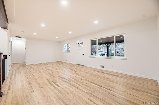 10751 W 66th Ave, Arvada, CO 80004 - unfurnished living room featuring recessed lighting, light wood finished floors, and visible vents
