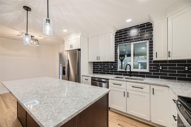 10751 W 66th Ave, Arvada, CO 80004 - kitchen with recessed lighting, a sink, light wood-style flooring, and stainless steel appliances